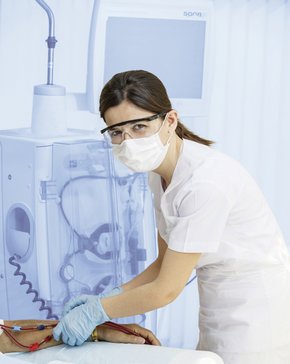 Dialysis nurse treats a patient